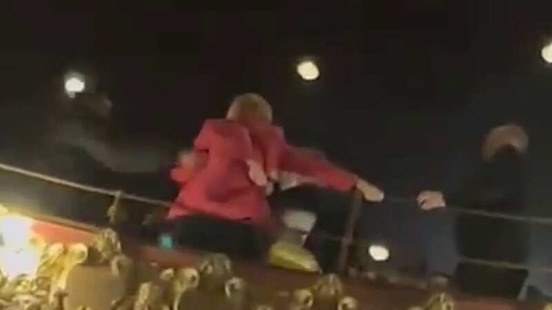Moment women dragged out of theatre after 