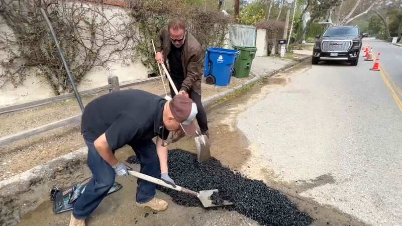 Arnold Schwarzenegger uploaded a video of himself filling pot holes on his street in Brentwood, Los Angeles (Image: AP)