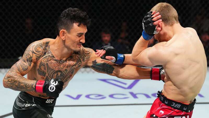 KANSAS CITY, MISSOURI - APRIL 15: (L-R) Arnold Allen of England punches Max Holloway in a featherweight fight during the UFC Fight Night event at T-Mobile Center on April 15, 2023 in Kansas City, Missouri. (Photo by Josh Hedges/Zuffa LLC via Getty Images)