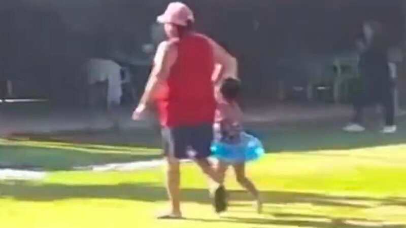 Parents drag their children away from the scene of the massacre