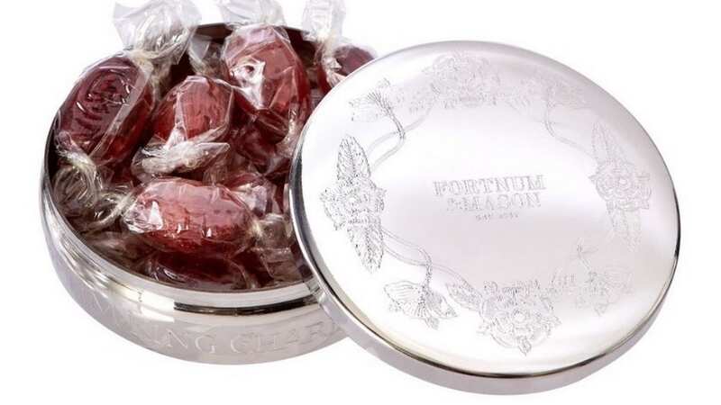 The individually wrapped sweets come in a metal tin engraved with the shop