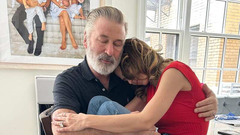 Tired Alec Baldwin holds wife in her emotional tribute after charges dropped