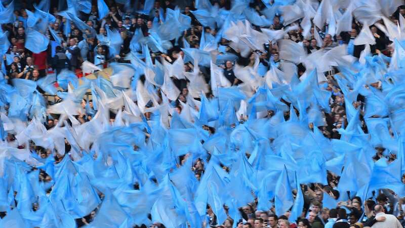 Manchester City fans wave flags in the crowd before kick off of the English League Cup final football match between Manchester City and Chelsea at Wembley stadium in north London on February 24, 2019. (Photo by Glyn KIRK / AFP) / RESTRICTED TO EDITORIAL USE. No use with unauthorized audio, video, data, fixture lists, club/league logos or 