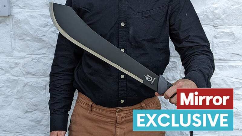 Our reporter poses with the horrifying weapon he was able to buy easily (Image: Daily Mirror)