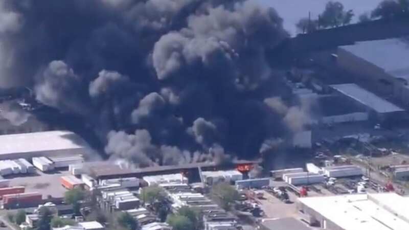 Massive fire tearing through warehouse with 