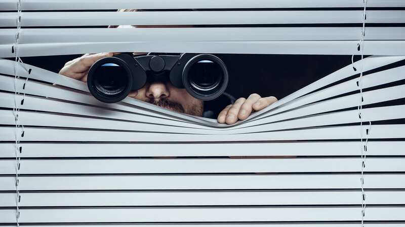 The neighbour admitted to peeping in the windows (stock photo) (Image: Getty Images)