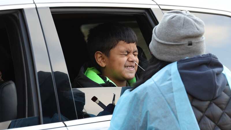 A boy gets tested at a drive through Covid-19 testing center (Image: Anadolu Agency via Getty Images)