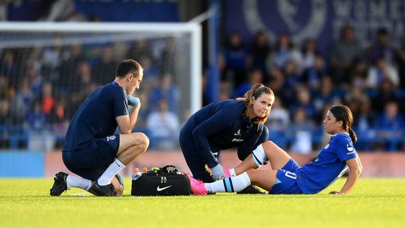 Sam Kerr receives medical treatment during Chelsea