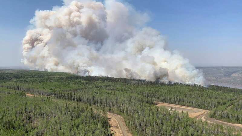 Thousands flee as wildfires tear through western Canada with emergency declared