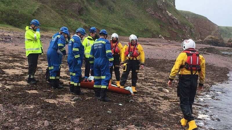 Dramatic images from the rescue mission show rescue teams scrambling through rocks before the casualty is carried by a stretcher onto a nearby beach (Image: Eyemouth Coastguard)