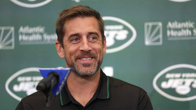 New York Jets quarterback Aaron Rodgers poses with a jersey during an introductory press conference (Image: Elsa/Getty Images)