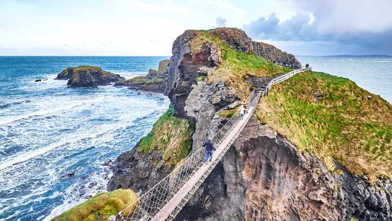 Causeway Coast Way walkers have to take on a perilous rope bridge (Image: Getty Images)