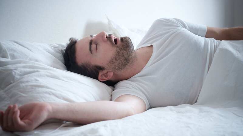A man snores loudly in his bed (file image) (Image: Getty Images/iStockphoto)