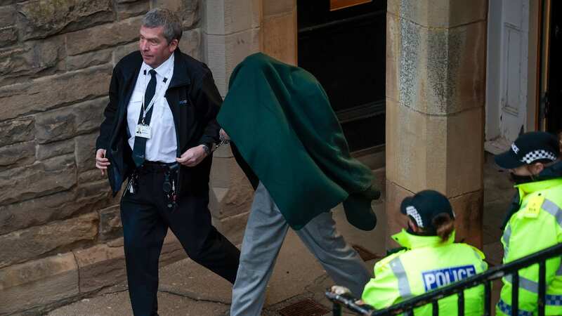 Andrew Miller is covered in a blanket as he is taken from Selkirk Sheriff Court (Image: Getty Images)