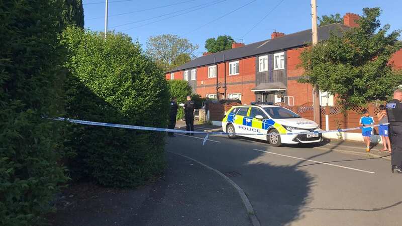 Police outside an address in Manchester (Image: MEN Media)