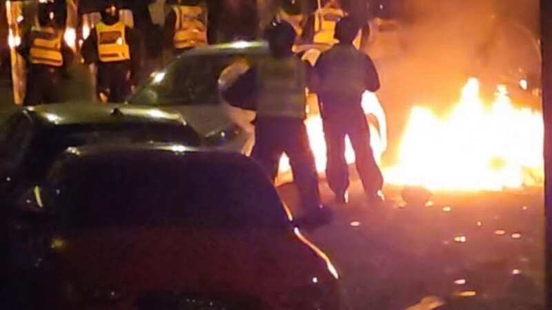 Police with riot shields as trouble flared in Cardiff (Image: WALES NEWS SERVICE)