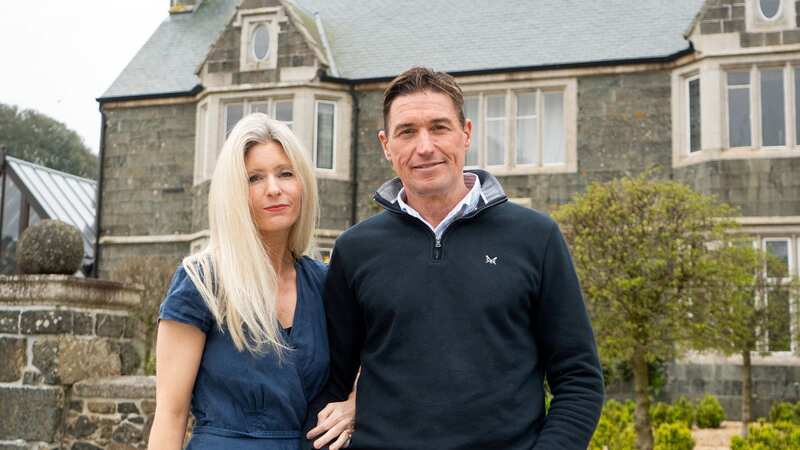 Martin and Sarah Caton outside their dream home, which soon turned into a nightmare (Image: SWNS)