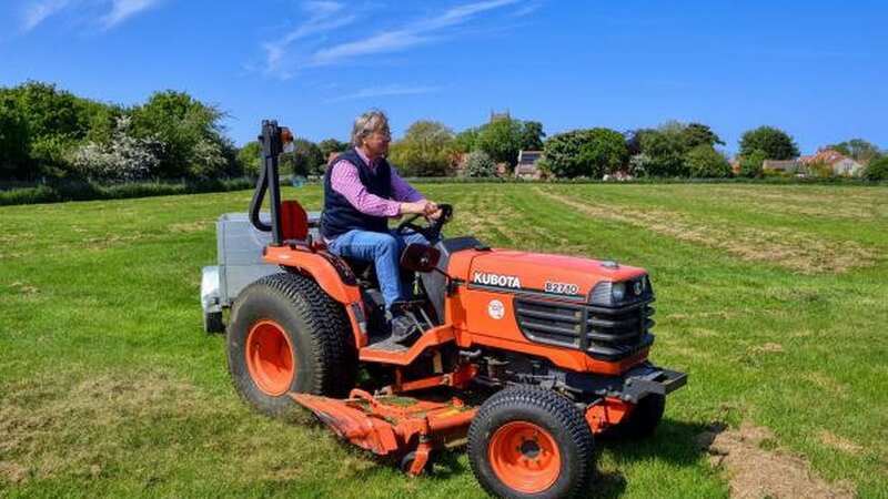 Malcolm Starr using a ride-on mower on his four-acre field at Holme (Image: Newsquest / SWNS)