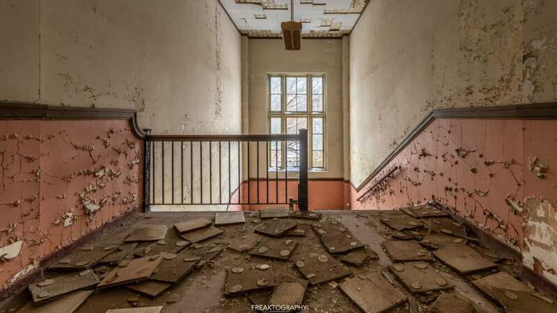 Abandoned school left to rot with old textbooks on floor and 