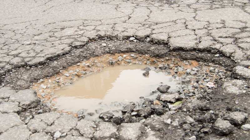 Dan Munford uses toy diggers to highlight the problem of potholes (Image: Dan Munford/WALES NEWS SERVICE)