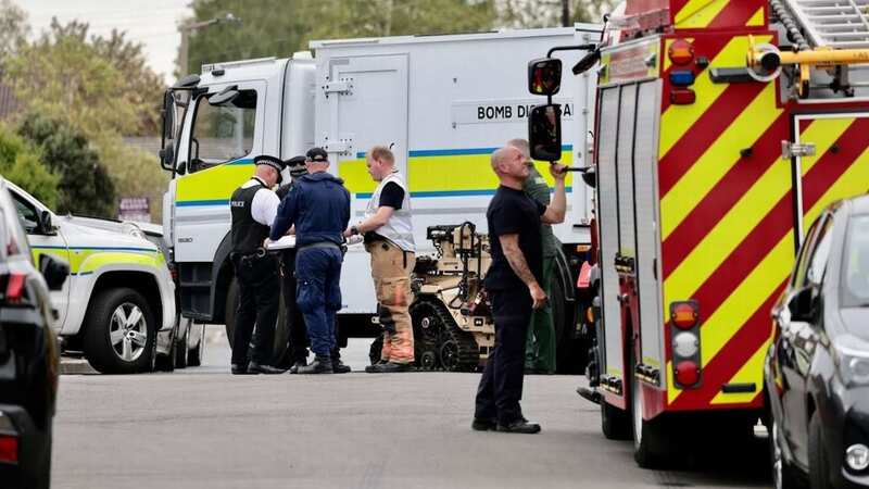 Experts outside the home in Stockport (Image: MEN)