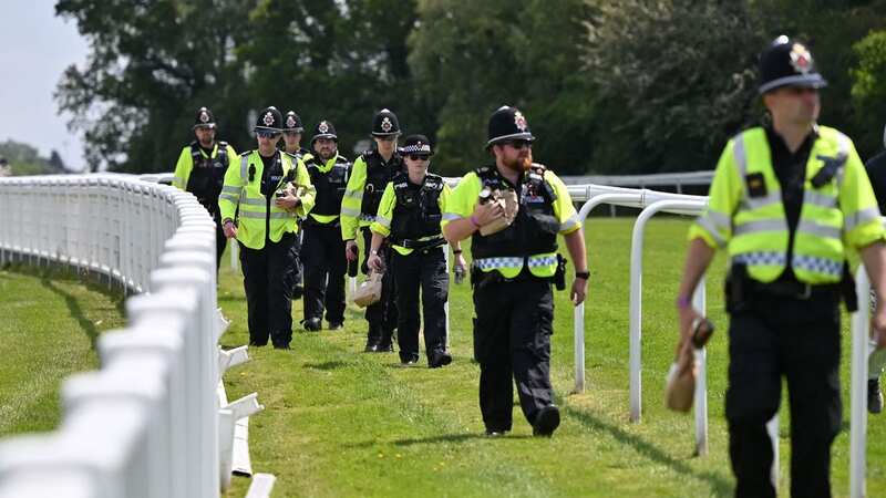 Police officers take up positions out on the course ahead of racing (Image: Getty)
