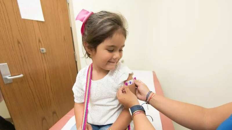 A nurse treats a little girl in hospital