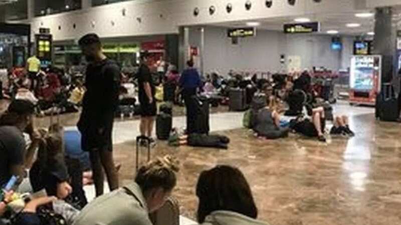 Crowds of people were pictured sitting in the terminal until around 4am - when they were offered accommodation for the night and flown back the following day (Image: MEN)