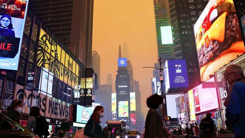 Times Square darkens with dark-brown smoke covering the sky due to wildfires in eastern Canada in Manhattan (Image: AP)