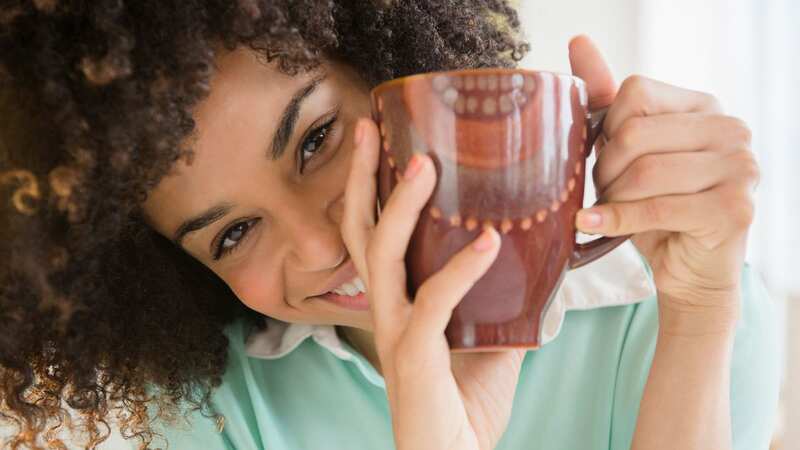 First sip of tea puts a smile on your face (Image: Getty Images/Tetra images RF)