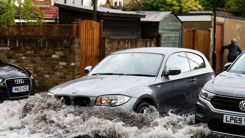 A car making its way through flood water in Twickenham (Image: Andrew Fosker/Seconds Left/REX/Shutterstock)
