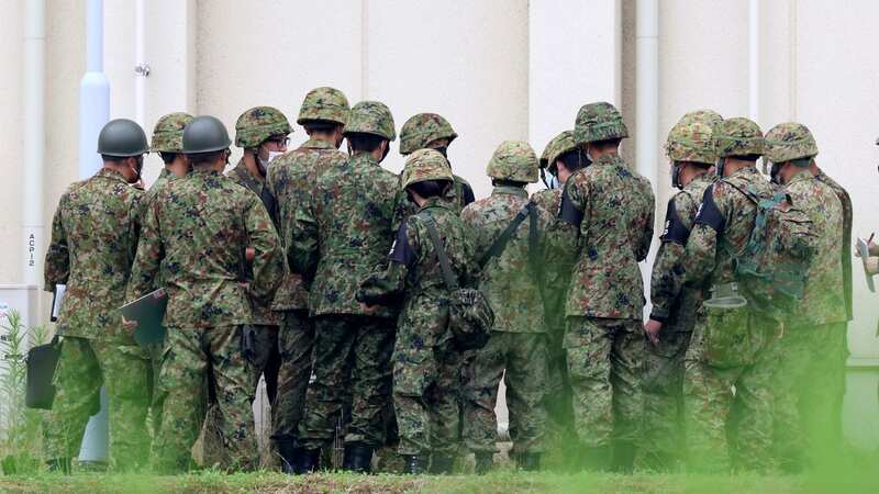 Members of the Self-Defense Force gather information related to the gunfire incident (Image: AP)