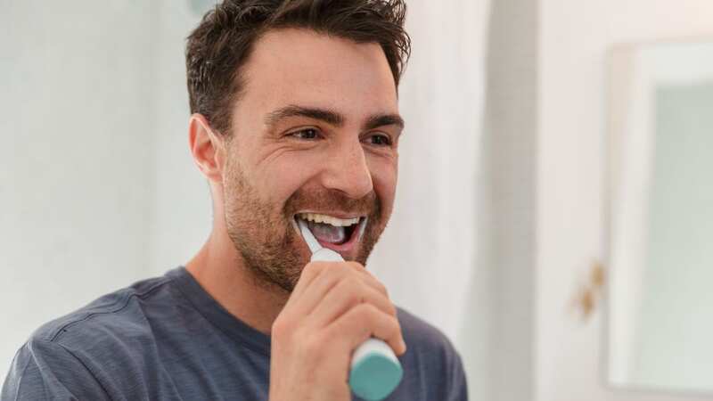 Four in ten Brits admit they brush their teeth for less than a minute a day, in total (Image: Lilly Bloom/Getty Images)