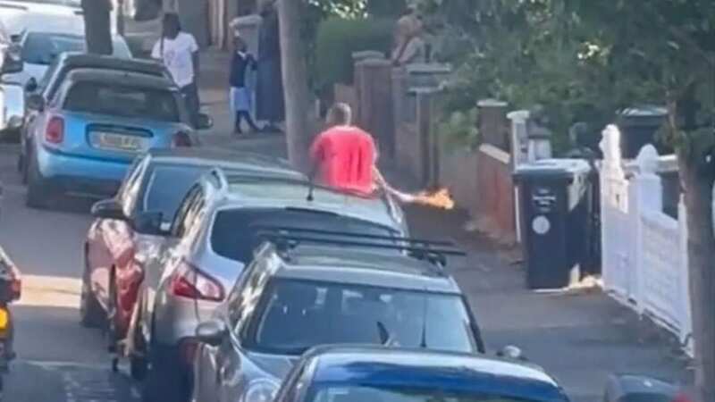 Moment man charges down street with Molotov cocktail as residents scream