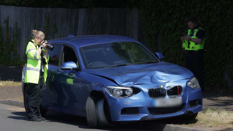 Officers were pictured examining a damaged BMW in nearby Springfield Road (Image: BPM Media)