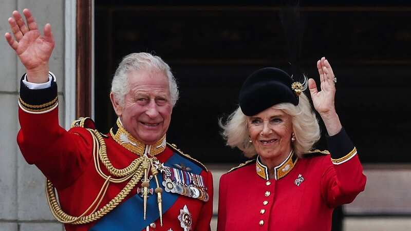 Queen Camilla could be seen giving King Charles an unusual nickname as they stood on Buckingham Palace (Image: AFP via Getty Images)