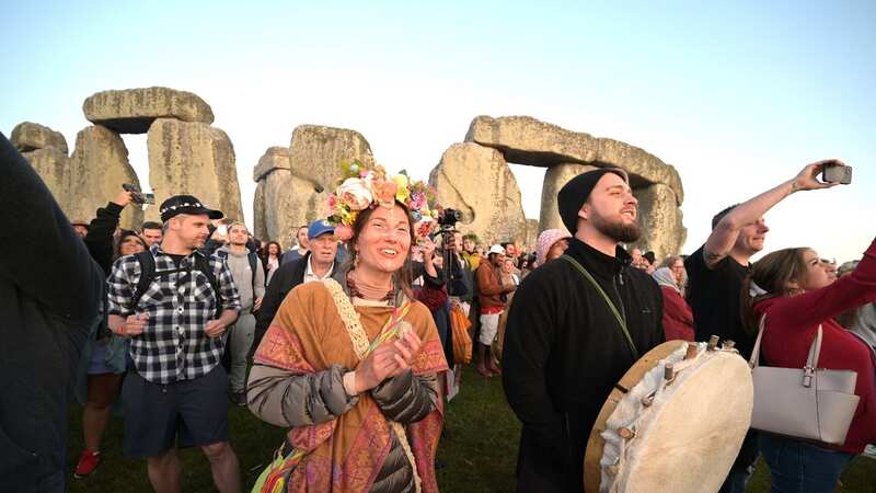 Pagans and druids watching the sun rise from the Stonehenge (Image: Martin Dalton/REX/Shutterstock)
