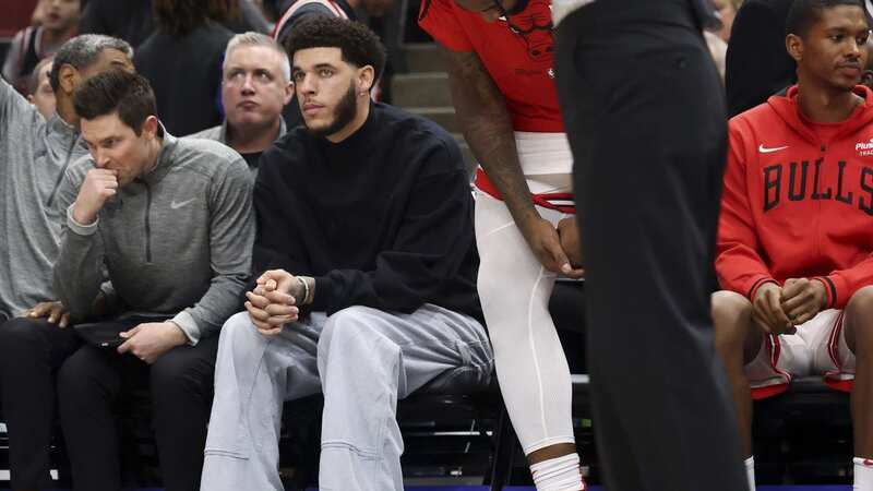 Bulls guard Lonzo Ball sits on the bench in street clothes
