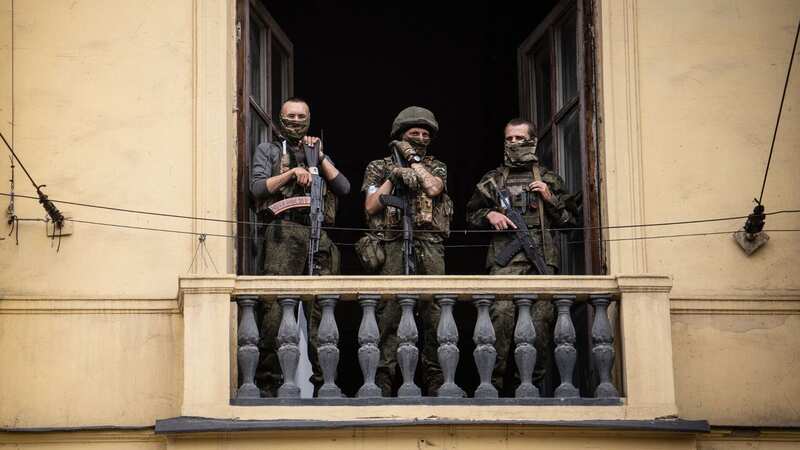 Members of Wagner Group stand on the balcony of the circus building in Rostov after reportedly seizing control of the city (Image: AFP via Getty Images)