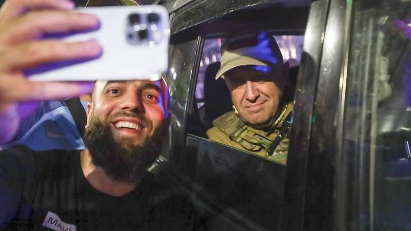 Yevgeny Prigozhin, the owner of the Wagner Group military company, right, sits inside a military vehicle posing for a selfie photo with a local civilian on a street in Rostov-on-Don, Russia, Saturday, June 24 (Image: AP)