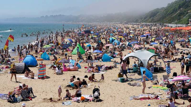 People enjoy the warm weather on Bournemouth Beach in Dorset (Image: PA)