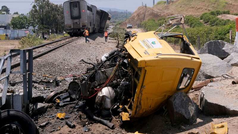 Horror pics show train wreck with 198 passengers derailed after hitting truck