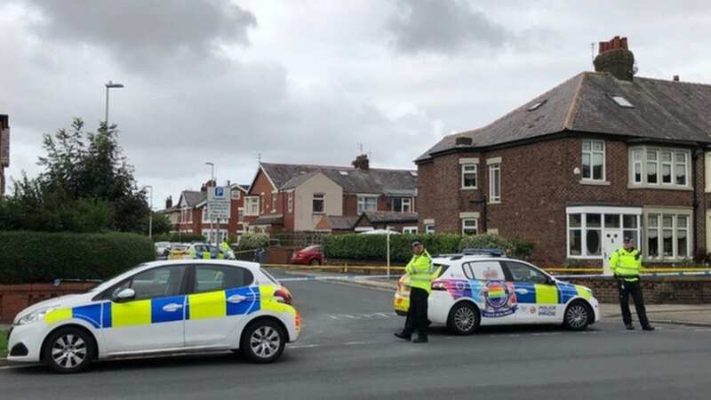 Police are pictured outside the home where Marlene McCabe was killed (Image: Lancashire Constabulary)