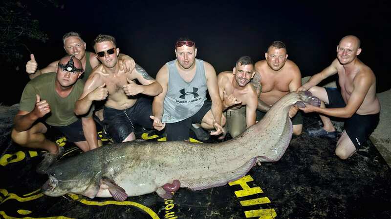 A group of friends were left speechless when a casual holiday fishing trip reeled in a 250lb beast (Image: Peter Irwin / SWNS)