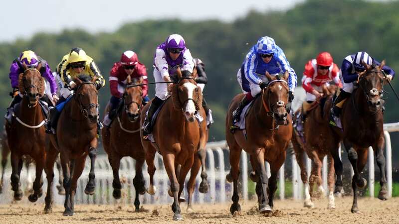 Calling the Wind ridden by jockey Neil Callan (centre, purple) wins the Jenningsbet Northumberland Plate from Golden Rules (blue colours) (Image: PA)