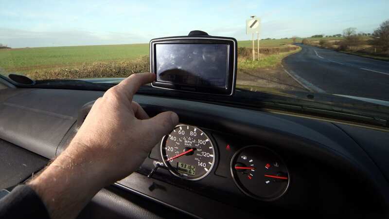 Anybody caught using a handheld phone while driving faces at least a £200 fine, and six penalty points on their license (Image: Getty Images)
