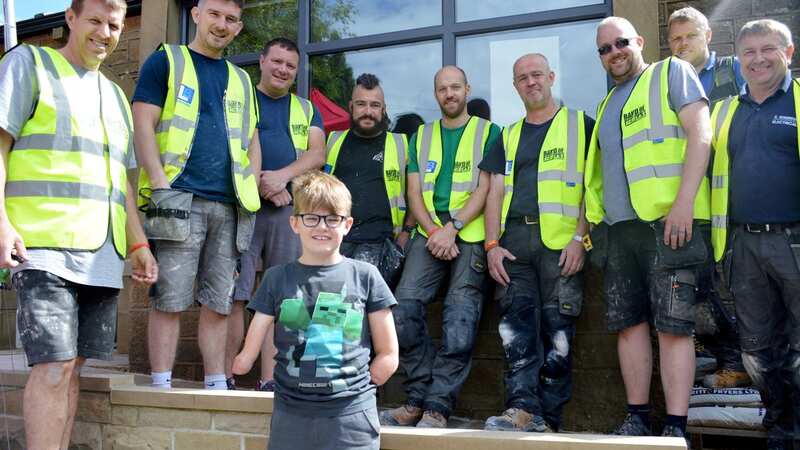 Luke Mortimer with the Band of Builders team (Image: BandofBuilders/AdamMortimer/SWNS)
