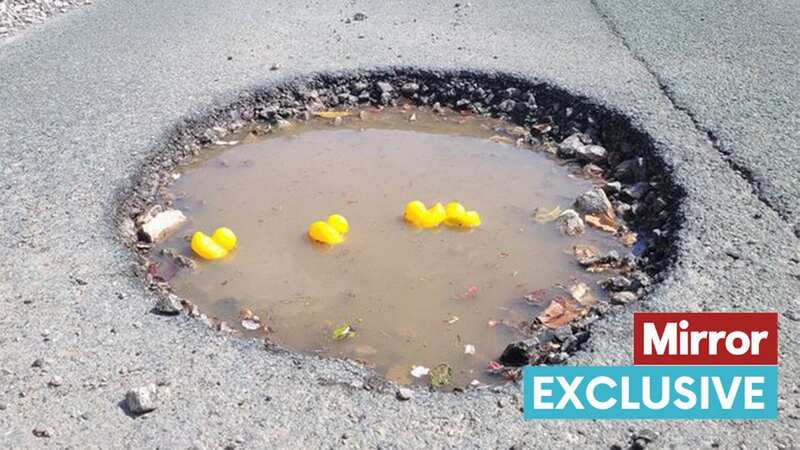 North Staffordshire villagers sick of a ginormous car-wrecking pothole on their street have used rubber ducks to highlight the scale of the crater (Image: Stoke Sentinel)
