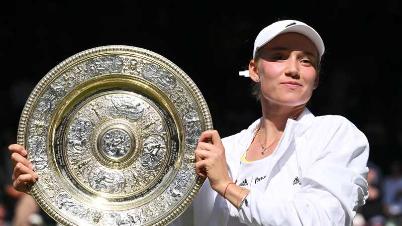 Elena Rybakina poses alongside her trophy after winning the Women