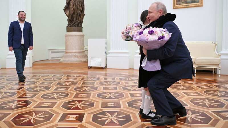 Putin chuckles as he hugs girl, 8, during Kremlin tour weeks after coup